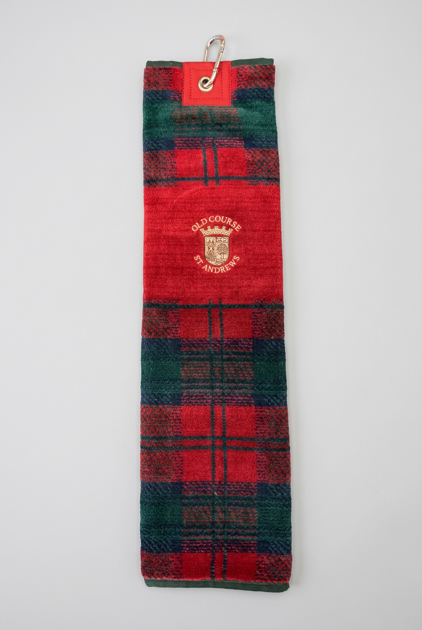 Red tartan velour golf towel with Old Course crest on a studio background